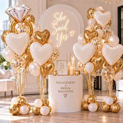 Elegant engagement and bridal balloon bouquets featuring gold diamond ring balloons, white hearts, metallic gold balloons and confetti balloons.