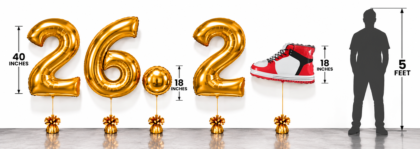 Gold 26.2 marathon balloons featuring 40-inch helium-filled foil numbers and an 18-inch gold circle balloon, with a 5-foot silhouette for size comparison.